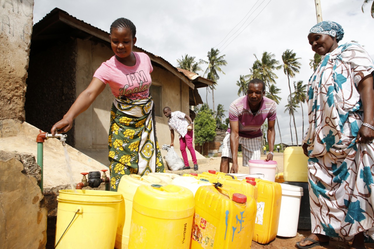 Local residents fetching water from their household yard tap